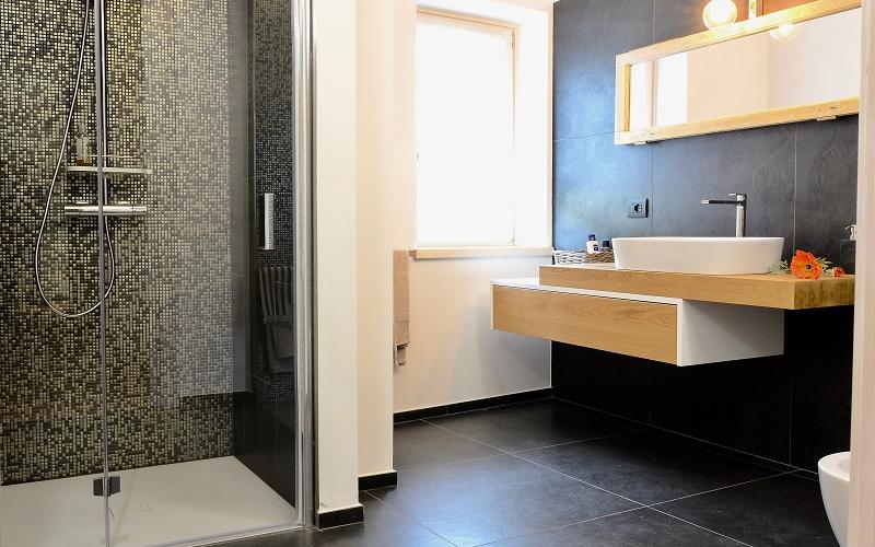 modern bathroom renovated dark tiles Verona